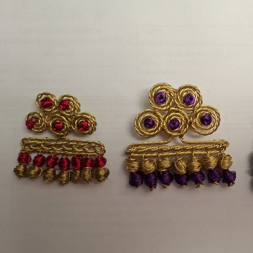 Broches de alambre dorado con cuentas rojas y moradas, Una de Belén